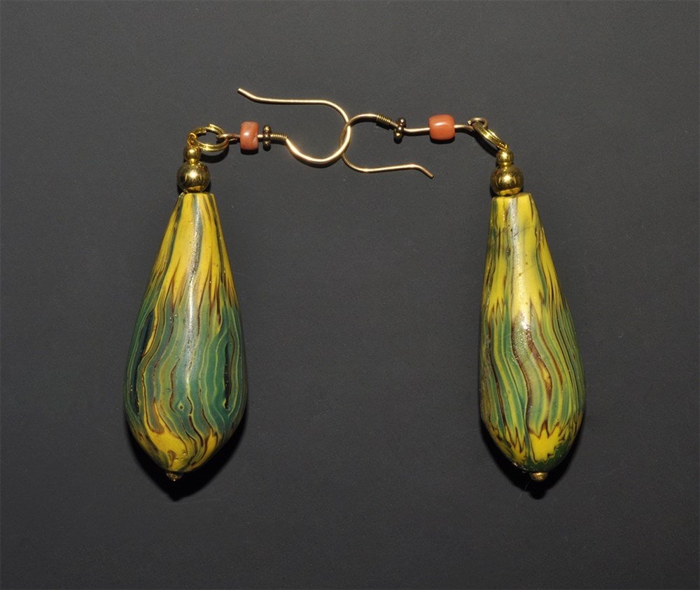Venetian Antique Venetian Glass Earring Pair: Circa 1900. A pair of antique earrings comprising a matched pair of elaborately made drop-shaped Venetian glass beads, using yellow and green star patterned Millefiori canes fused together longitudina
