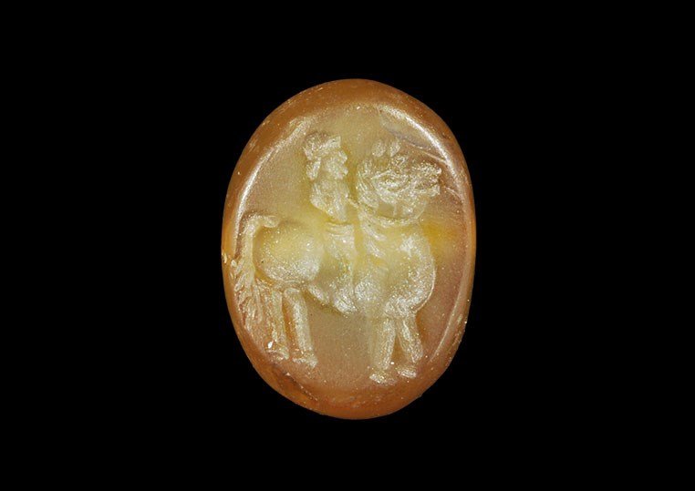 Near Eastern Sassanian Stone Stamp Seal with Horse and: Sassanian Empire, 224-651 AD. A carved amber-coloured pierced stone with intaglio design to the flat face of a bearded man riding a bridled horse. 3.92 grams, 17 mm (3/4"). From a London collection; a
