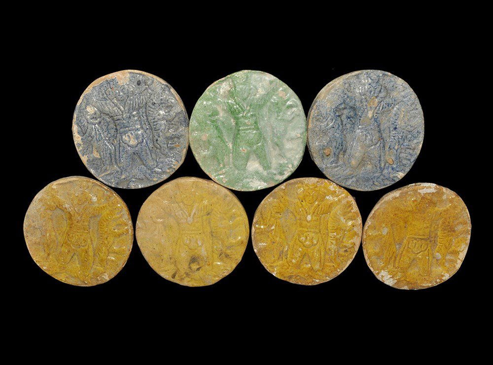 Near Eastern Glazed Ceramic Circular 'Master of: A mixed group of undated archaistic flat-section discoid tiles with high-relief design of the Master of Animals, one with green glaze, two with blue and four with ochre. 935 grams total, 10 cm each (4