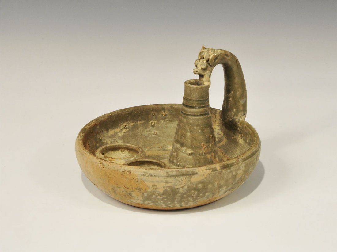 Cambodian Style Ceramic Offering Cup with Dragon Handle: An undated archaistic green-glazed ceramic bowl with hollow conical fitting and dragon-shaped handle, two small bowls within. 1 kg, 18.5 cm (7 1/4"). Property of a London collector, acquired before 19
