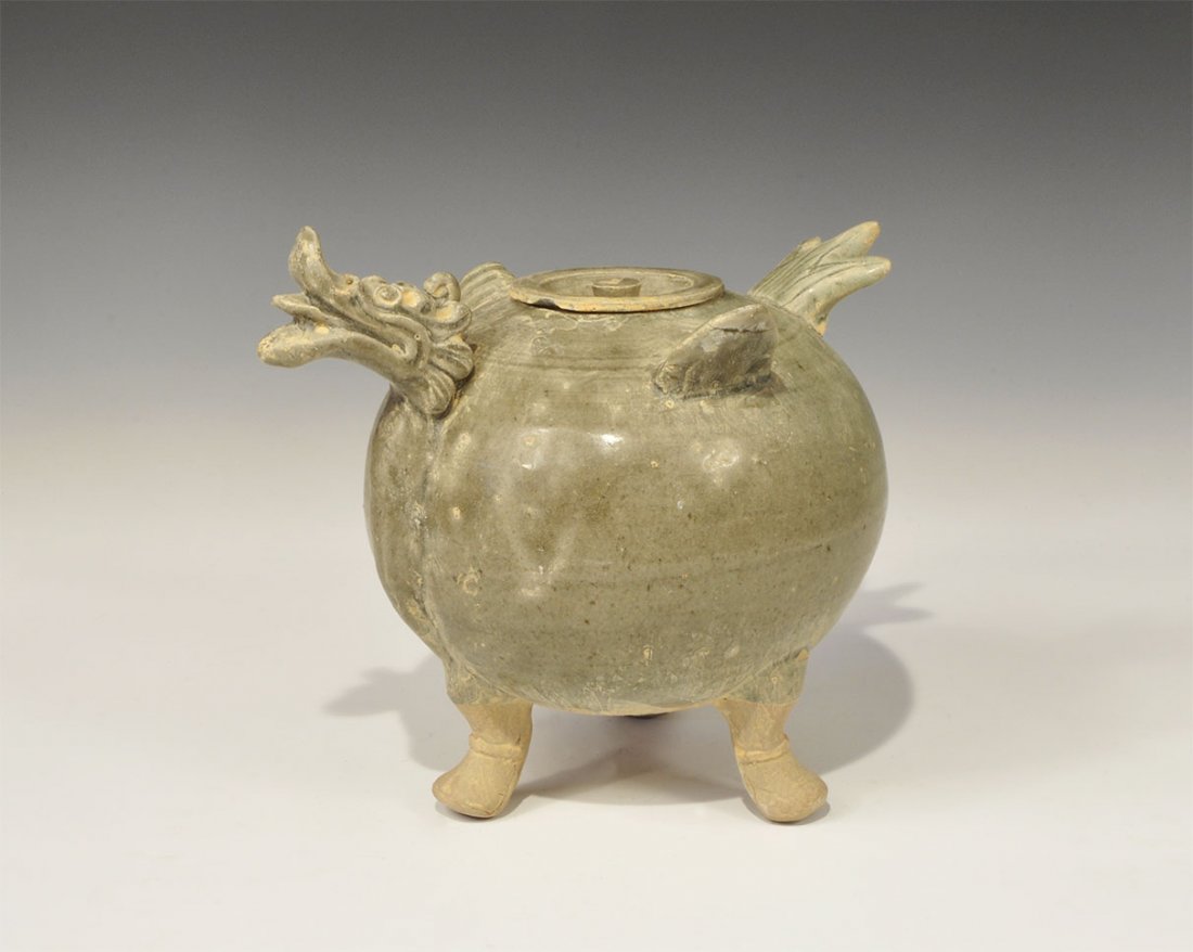 Cambodian Style Ceramic Dragon Teapot: An undated archaistic green-glazed ceramic teapot with three short feet, moulded head and tail details, D-shaped flange handle and conical spout. 1.9 kg, 23.5 cm (9 1/4"). Property of a London collect