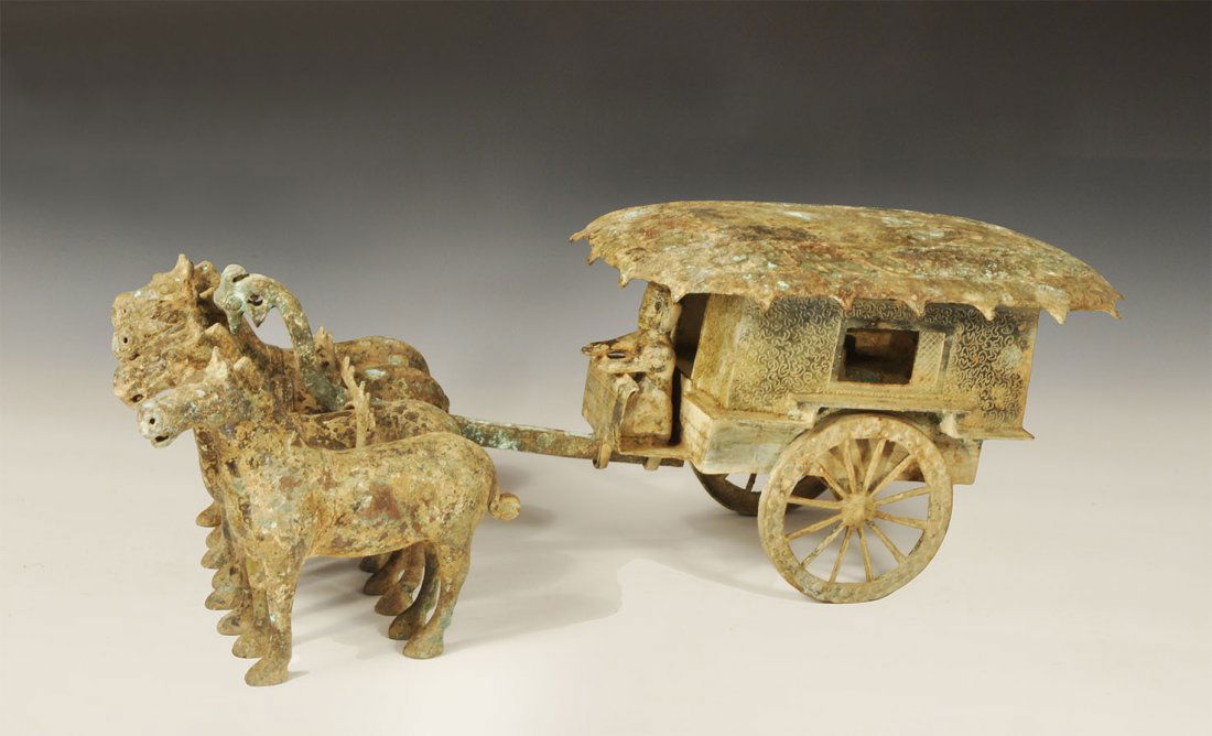 Chinese Style Large Bronze Carriage with Driver and: An undated archaistic carriage diorama with dished scroll-decorated cover to the two-wheeled waggon, integral driver figure to the front; separate yoke and pole; four hollow-cast horses. 16.2 kg total