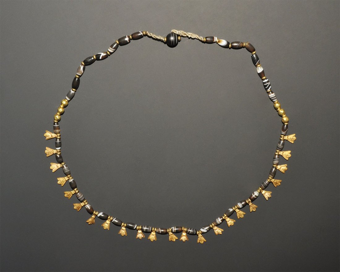 Near Eastern Solaimani Small Agate Bead and Gold: An undated archaistic necklace of banded agate beads with gold globular beads and cicada pendants. 17 grams, 49 cm (19 1/4"). Property of a London Gentleman; acquired prior to 1994.