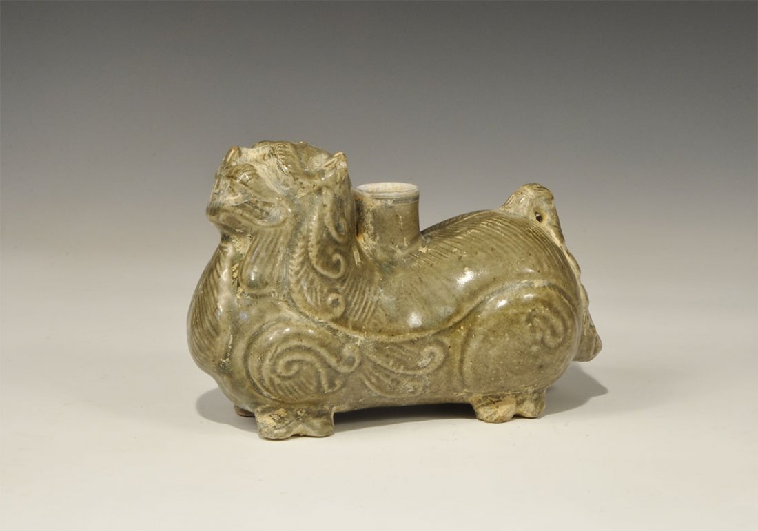 Cambodian Style Ceramic Lion Vessel: An undated archaistic hollow green-glazed lion vessel with tubular socket to the central back. 1.1 kg, 20 cm (8"). Property of a London collector, acquired early 1990s.