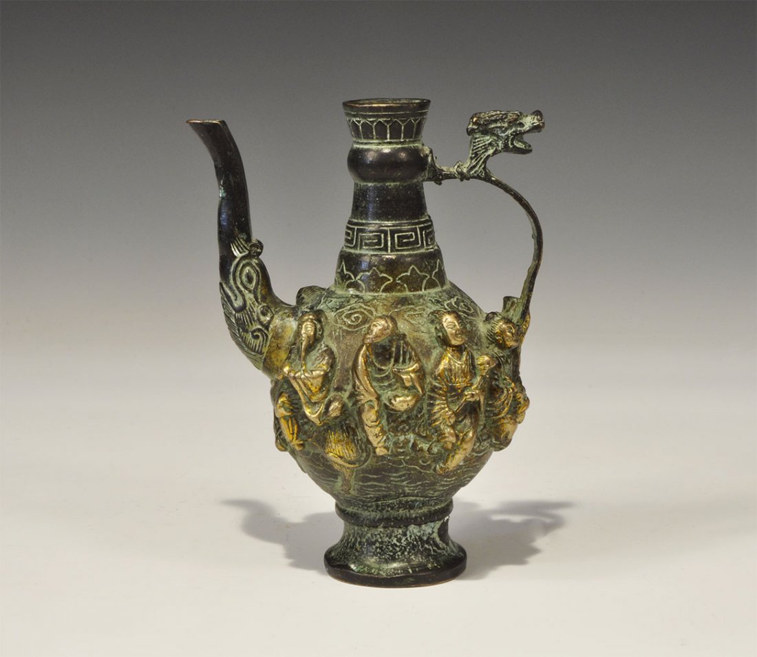 Chinese Style Gilt-Bronze Ewer with Dragon Handle: An undated archaistic cast ewer with strap handle and conical neck; to the shoulder, eight high-relief figures; reserved signature to the underside. 359 grams, 15 cm (6"). Property of a London Gentlem