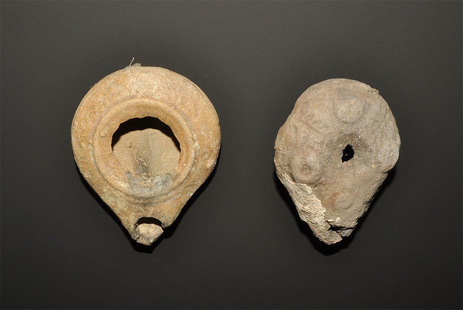 Roman and Byzantine Ceramic Lamp Group: 4th-6th century AD. A group of two ceramic oil lamps, one discoid with large void to the upper face.one slipper=shaped with raised pellets. 116 grams total, 73-80 mm (3 - 3 1/4"). Property of a Camrbi