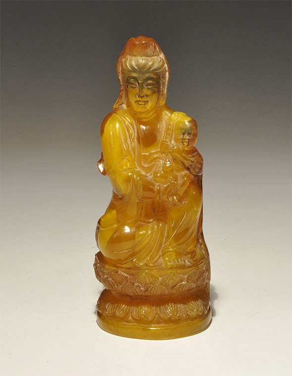 Chinese Style Composite Faux-Amber Maya and Buddha: An undated archaistic composition statuette of Queen Maya cradling the infant Gautama Buddha on a lotus flower base. 220 grams, 14.5 cm (5 3/4"). London private collection, acquired 1990s-2000.