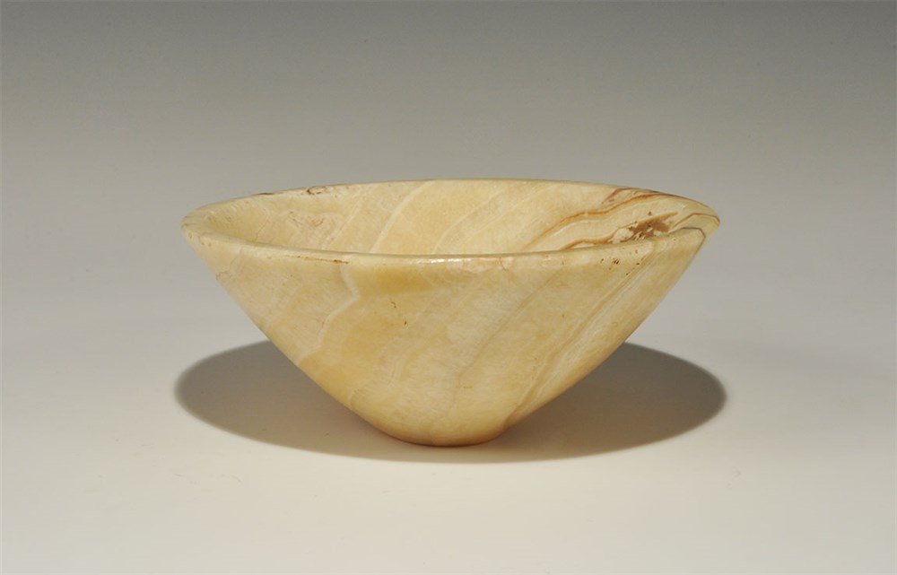 Greek Bactrian Alabaster Bowl: An undated archaistic calcite alabaster carved bowl with narrow base and conical profile. 637 grams, 16 cm (6 1/4"). Acquired on the London art market in the 1960s. Alabaster is a name applied to vari