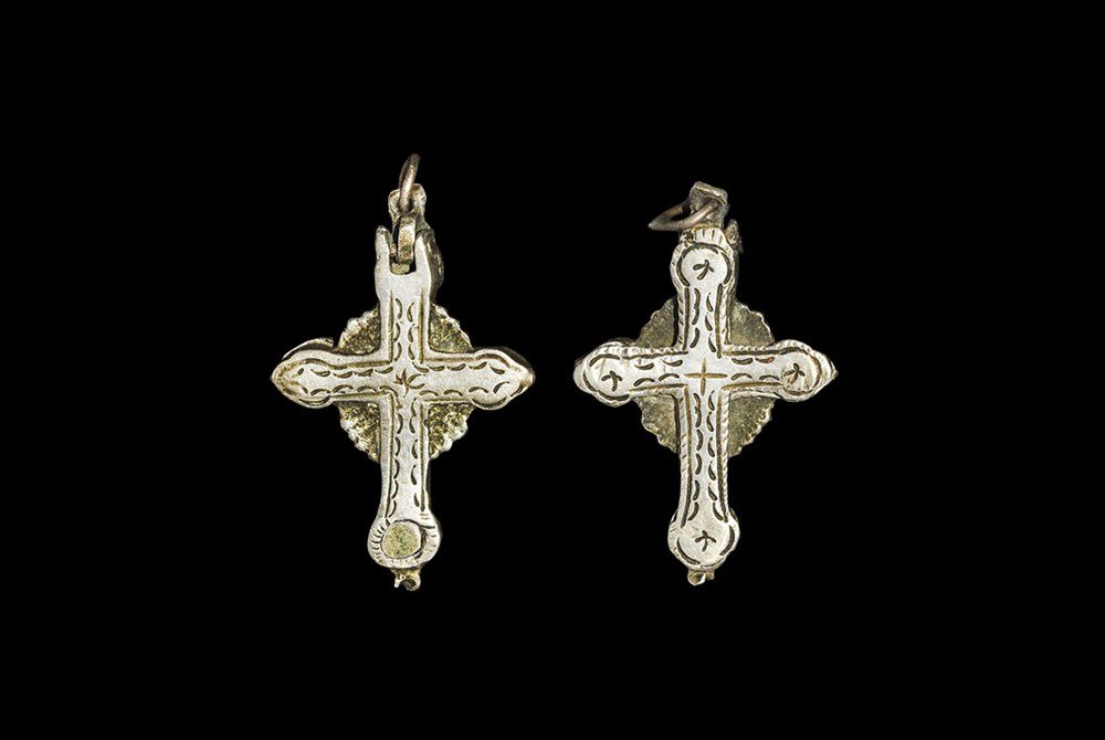 Medieval Silver Nun's Reliquary Pendant: 16th century AD. A cruciform pendant with suspension loop, hinged hollow lower plate with four quadrants; bands of stamped ornament to each face. 6.00 grams, 38 mm (1 1/2"). Ex Morris collection, Buck