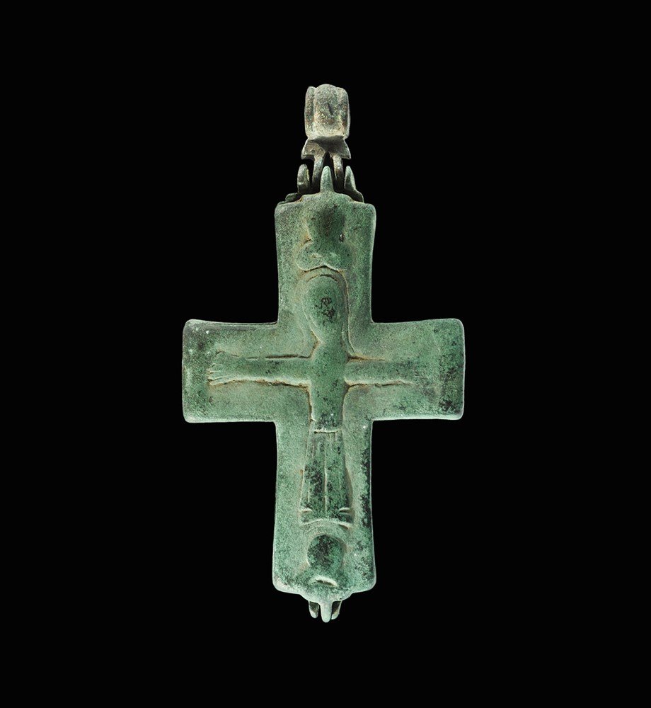 Byzantine Bronze Reliquary Cross Pendant: 5th-8th century AD. A cast reliquary pendant, hinged below and with separate suspension loop, image of Christ crucified to one face, infant Christ and Mary Theopheros to the other with figural roundel