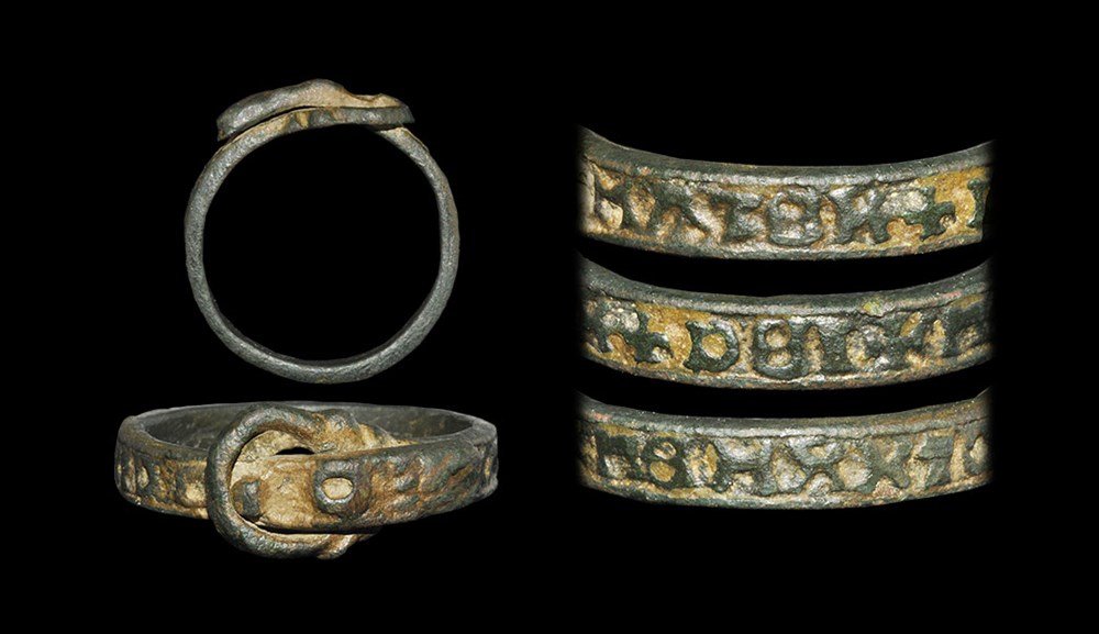 Medieval Bronze 'Mater Dei' Inscribed Buckle Ring: 14th-16th century AD. A flat-section hoop with dummy loop and tongue, reserved text to the outer face 'MATER+DEI+MEM[,,,]O' (Mother of God ...) 4.78 grams, 26 mm overall, 21.11 mm internal diameter (a