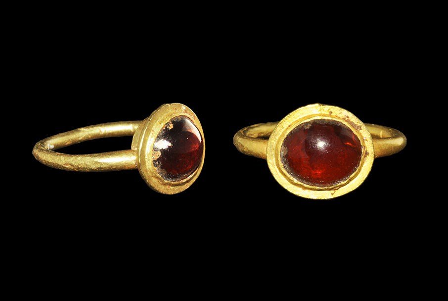 Roman Gold Miniature Ring with Cabochon Garnet: 1st-2nd century AD. A small round-section hoop with elliptical bezel, inset cabochon garnet. 1.11 grams, 14 mm overall, 9.47 mm internal diameter (size unclassified) (1/2"). Private UK collection, by 