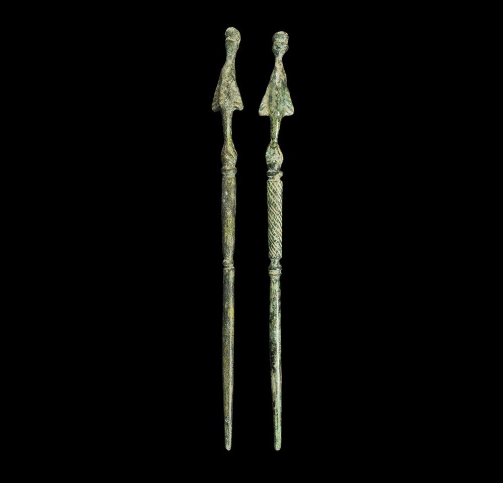 Roman Bronze Figural Topped Stylus Pair: 3rd-4th century AD. A pair of cast pins, round in section and balustered, each with a finial formed as a leaping dolphin. 19 grams total, 12 cm (4 3/4"). Ex Headington collection, London, UK; thence b