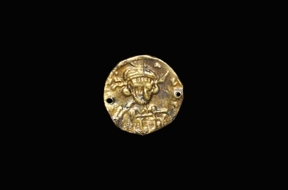 Byzantine Gold Repoussé Figural Bracteate: 7th century AD. A sheet-gold monofacial repoussé bracteate with the facing bust of a Byzantine Holy Emperor, probably Constantine IV, Pogonatus (Senior Augustus 15th July 668-10th July 685 AD), in mi