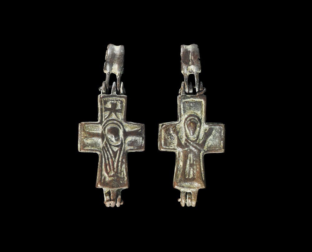Byzantine Bronze Reliquary Cross Pendant: 5th-8th century AD. A bifacial reliquary cross pendant with hinge and separate loop; to one face Christ on the cross, to the other Christ risen. 9.23 grams, 44 mm (1 3/4"). Property of a London collec