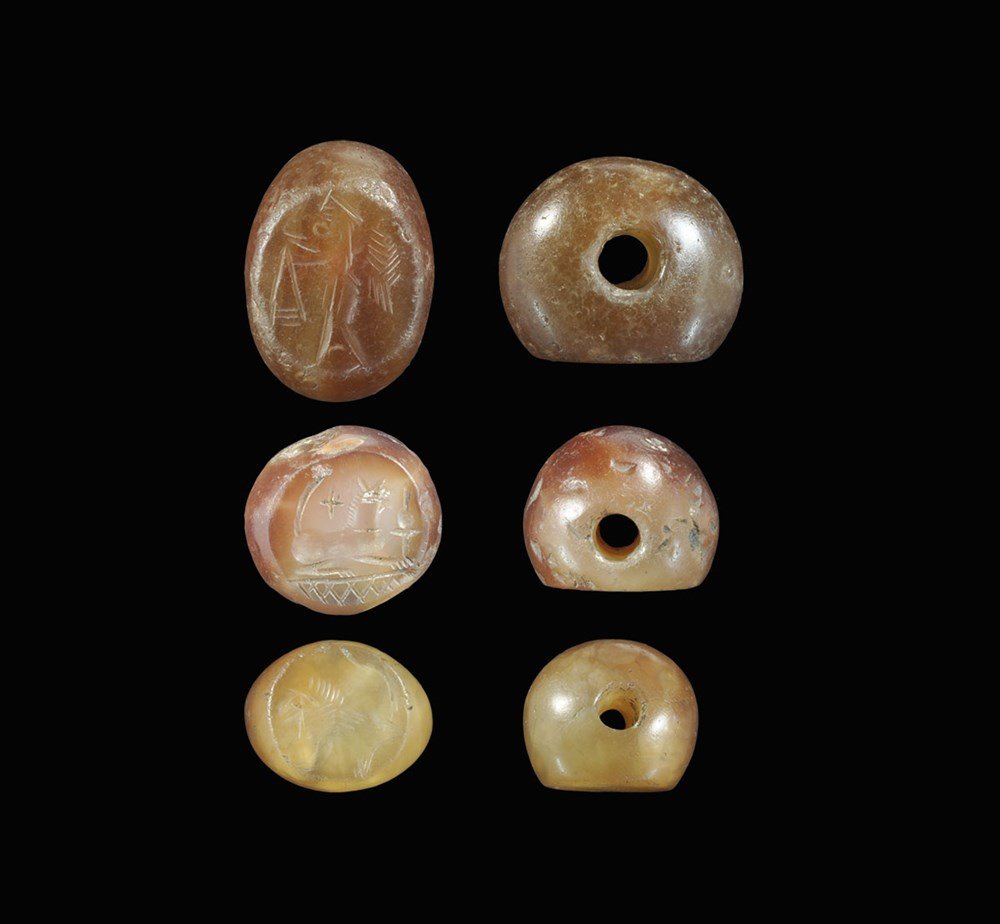 Near Eastern Sassanian Carnelian and Agate Stamp Seal: 224-651 AD. A mixed group of stamp seal matrices comprising: one a standing winged figure with arms extended; one a crouching lion; one a crouching lion on a hatched base with objects in the field, tw