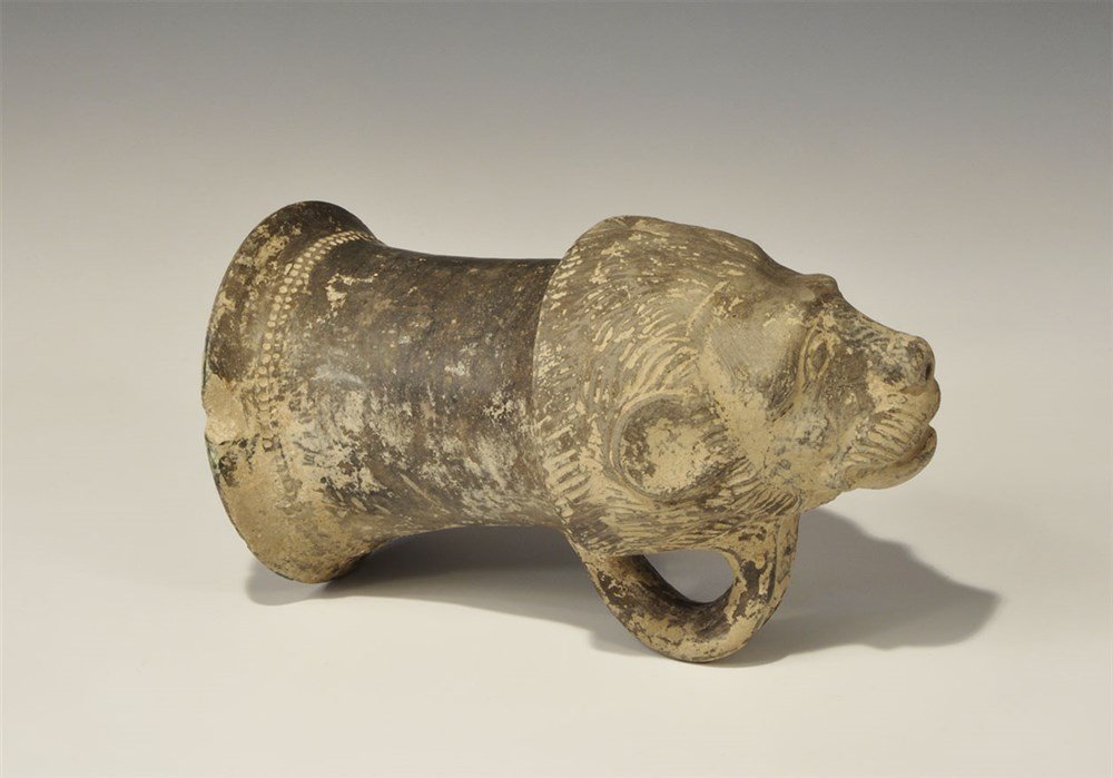 Near Eastern Graeco-Achaemenid Ceramic Rhyton: 5th-4th century BC. A broad rhyton with bell-shaped upper, loop handle and lion-mask to the lower end, pierced at the nose; a band of impressed pellets to the neck. 669 grams, 20 cm (8"). From an old