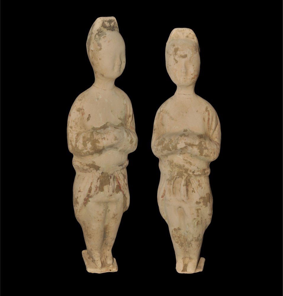 Chinese Terracotta Funerary Figure Pair: Han Dynasty, 206 BC-220 AD. A group of two hollow-cast figurines, each a standing attendant with hands folded at the chest. 923 grams total, 26.5 cm each (10 1/2"). Ex Steinberg collection; acquired o
