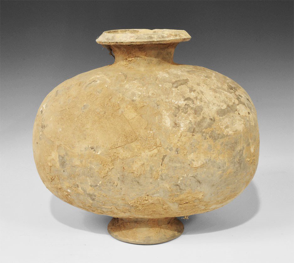 Chinese Ceramic Cocoon Jar: Han Dynasty, 206 BC-220 AD. A greyware cocoon jar with original pigmentation, bands of orange and white geometric designs; foliate detail in white and ochre to the ends. 2.9 kg, 28 cm (11"). UK art ma