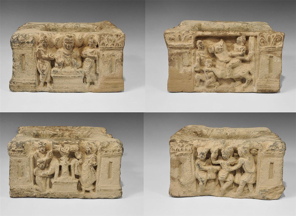 Gandharan Schist Figural Column Section: 1st-3rd century AD. A carved section of a figural column, square in plan, with high-relief carving to each face comprising: a horseman with a kneeling and a standing figure; a dancer with two attendan