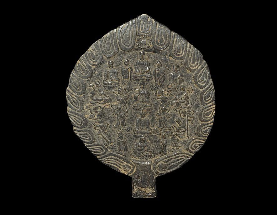 Chinese Style Bronze Hand Mirror: An undated archaistic leaf-shaped hand mirror with one polished face, panel of figural scenes to the reverse within a border of stylised flames. 985 grams, 23 cm (9"). From a central London collection