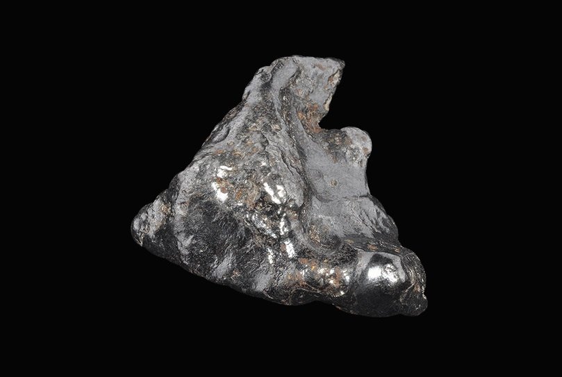 Geological Sikhote-alin Meteorite: An iron meteorite classed as Octahedrite, Class IIAB from the observed fall near Sikhote-alin, Siberia, in 1947, showing classic ablation 'fingerprints' and a black fusion-crust surface. Meteoritical