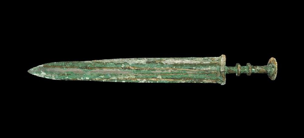 Chinese Han Style Bronze Short Sword: An undated archaistic cast short sword with broad ribbed blade, scaphoid-section guard columnar grip with two collars and a dished discoid pommel. 855 grams, 49.5 cm (19 1/2"). From an old London coll