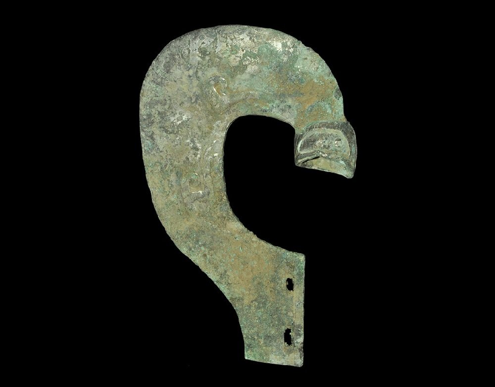 Chinese Style Tinned Bronze Halberd with Animal Head: An undated archaistic bronze halberd blade in Zhou Dynasty style, C-shaped in plan, decorated with serpentine patterning in low relief; tang and hollow socket pierced for attachment. 549 grams, 20.5 c