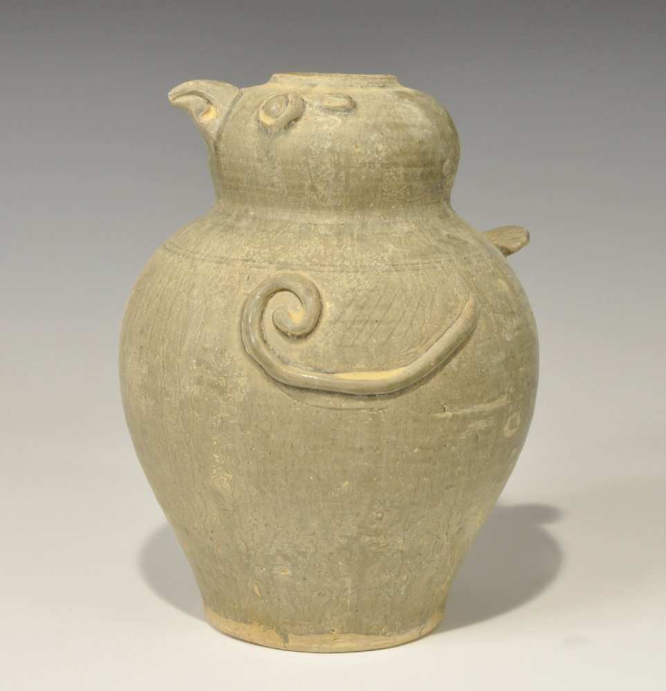 Cambodian Style Ceramic Glazed Bird Vessel: An undated archaistic celadon-ware vessel with applied bird-head detailing, spiral wings and ledge tail. 1.5 kg, 23.5 cm (9 1/4"). Property of a London Gentleman; acquired before 1996.