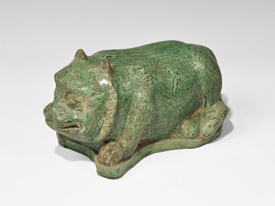 Cambodian Style Glazed Ceramic Bear Figurine: An undated archaistic green-glazed figurine of a crouching bear on an irregular base, hollow to the underside. 2.2 kg, 28.5 cm (11 1/4"). From a South West London collection; formed 1990-2000. [No Res