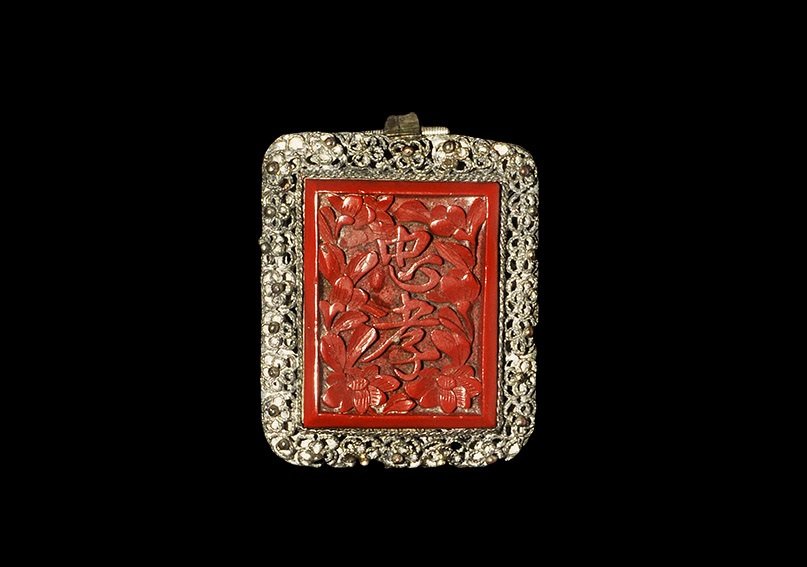 Chinese Silver Brooch with Carved Panel: An undated archaistic rectangular brooch with filigree and granule flowers surrounding a rectangular carved plaque with foliage and four characters; sprung clip to the reverse. 10 grams, 38 mm (1 1/2"