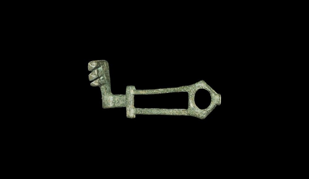 Roman Bronze Openwork Key: 1st-2nd century AD. A cast latch key with openwork rectangular handle and pierced lozengiform finial, flat-section shank and bits to the forward edge. 34 grams, 73 mm (3"). Ex Heddington collection, L