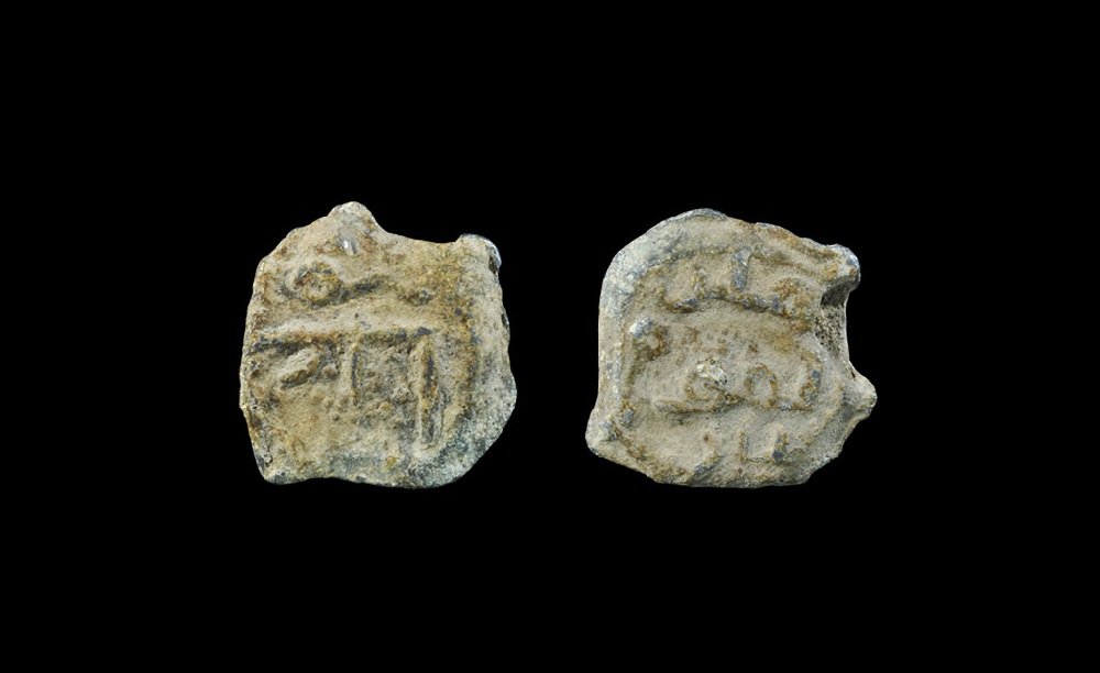 Islamic Lead Bulla Seal: 8th-10th century AD. A flat-section discoid seal with script to one face and geometric design to the other. 4.83 grams, 18 mm (3/4"). Property of a US collector. [No Reserve]