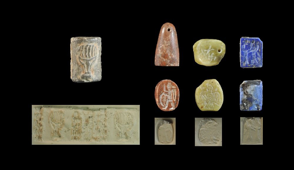 Near Eastern Sassanian Style Stone Seal Group: A mixed group of undated archaistic seals comprising: a cylinder seal with flaming chalice flanked by two standing figures; a conical seal with standing figure; a discoid seal pierced in two planes wi