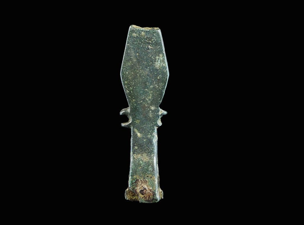 Norman Bronze 'Griffon' Strap-End: 12th century AD. A cast bronze lozengiform strap-end with split bar and lateral crescent extensions; the upper face with incised scene of a winged beast facing right and bird-head facing right, punche