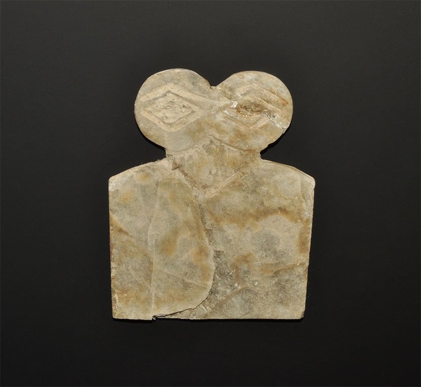 Near Eastern Alabaster Eye Idol: Circa 3000 BC. An alabaster eye idol, flat in section, with trapezoidal body and two large discoid eyes above. Accompanied by an old hand written scholarly note by W.G. Lambert, late Professor of Assy