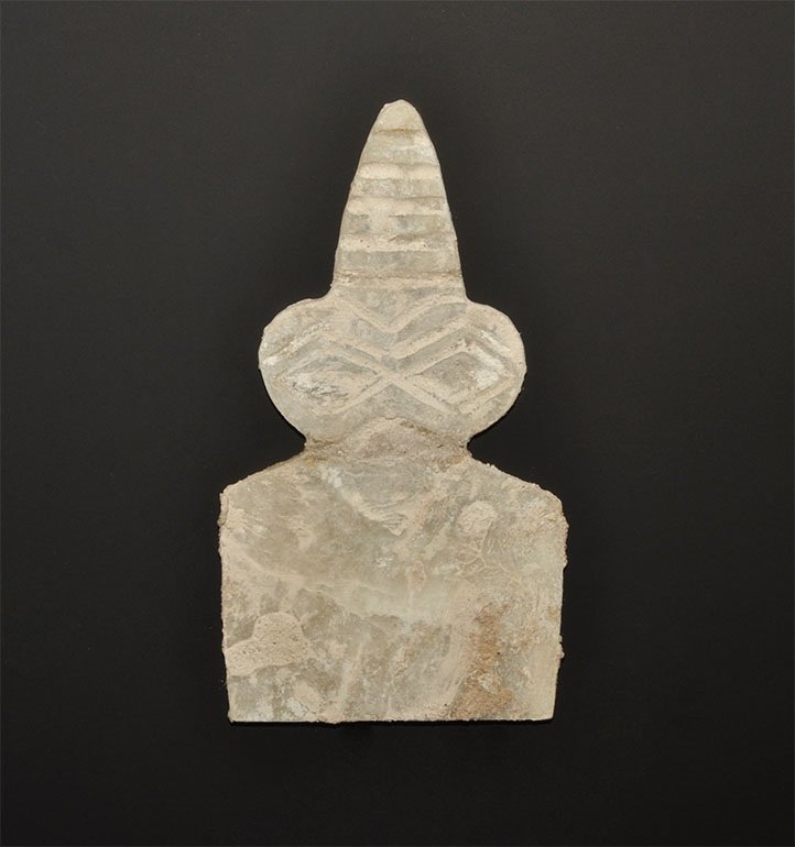 Near Eastern Alabaster Eye Idol with Tiered Coiffure: Circa 3000 BC. An alabaster eye idol, flat in section, with trapezoidal body and two large discoid eyes above and six-tiered coiffure. Accompanied by an old hand written scholarly note by W.G. Lambert