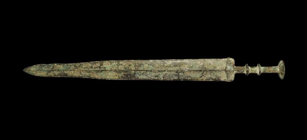Chinese Style Bronze Short Sword: An undated archaistic cast bronze short sword in Han Dynasty style, with midrib to the waisted blade; elliptical guard, two transverse discoid collars to the grip and large discoid pommel above. 755 g