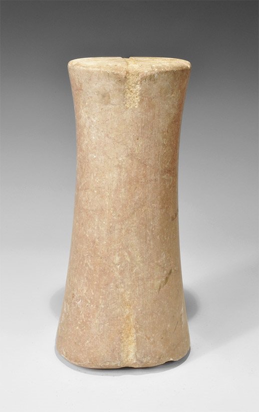 Near Eastern Bactrian Style Stone Idol: An undated archaistic carved stone idol, round in section, waisted, with shallow slot to the upper and lower faces. 10 kg, 33.5 cm (13 1/4"). Ex South London collection; acquired in the late 1990s.