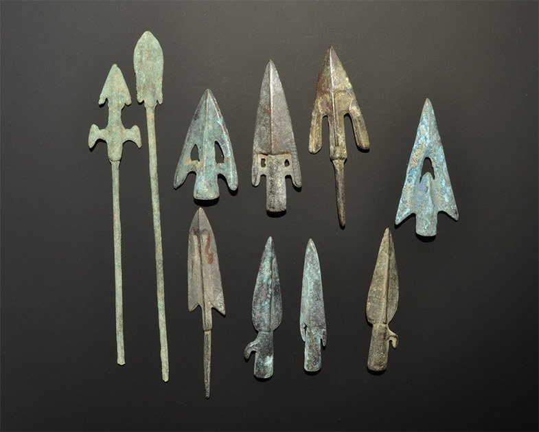 Greek and Near Eastern Style Arrowhead Collection: A mixed group of undated archaistic cast bronze arrowheads comprising: two leaf-shaped, socketted, lateral spur; four triangular, socketted; four triangular, tanged. 232 grams, 5-17 cm (2 - 6 3/4"). P
