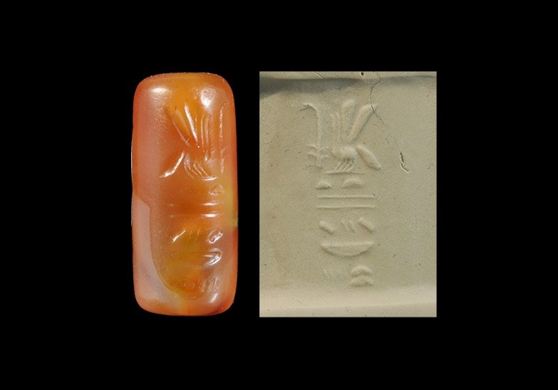Egyptian Carnelian 'King of Upper and Lower Egypt': 18th Dynasty, 1550-1292 BC. A carved cylinder seal with chamfered edges to the ends, median piercing; incised vertical block of hieroglyphic text. Property of a gentleman; formerly in a private collec