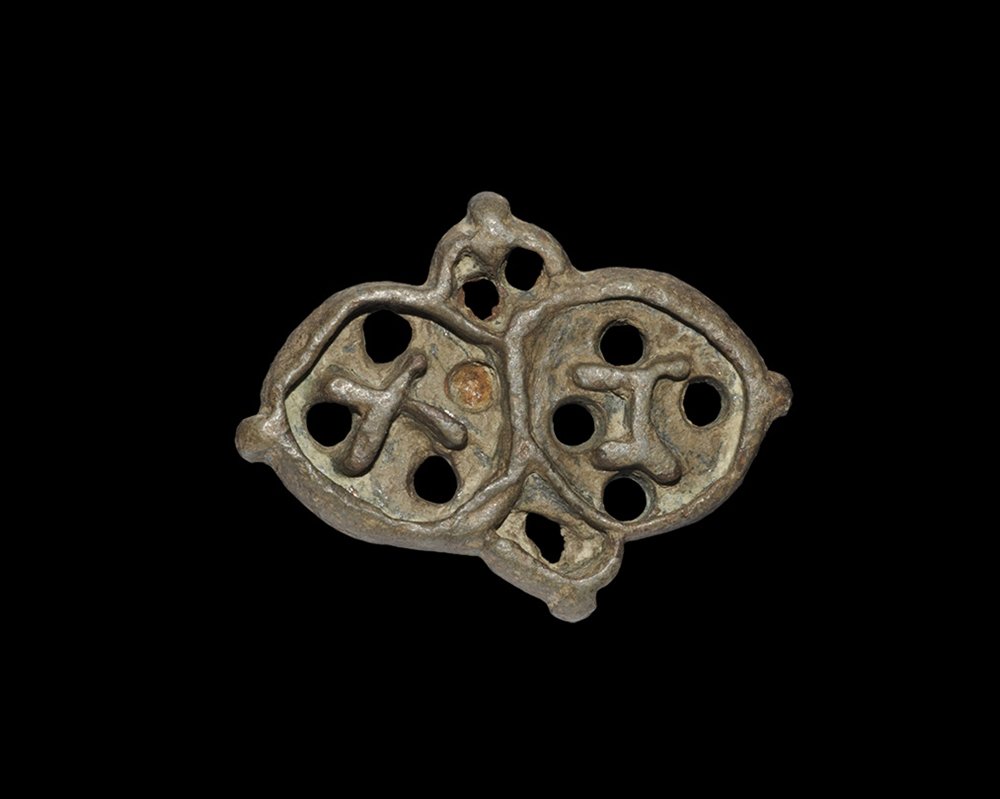 Byzantine Bronze Bread Stamp: 9th-12th century AD. A cast stamp formed as four lobes, pierced lug to the reverse; the design with raised borders to the lobes, the larger two containing the letters gamma and chi. Private collection