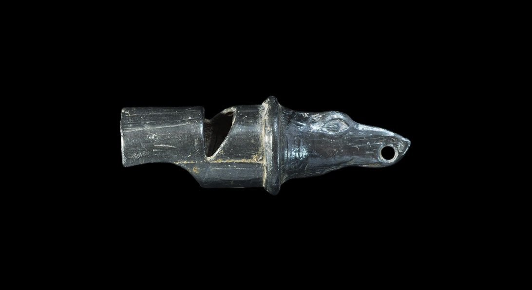 Post Medieval Pewter Hawking or Hunting Whistle: 18th century AD. A cast whistle with tubular body, scooped mouthpiece, flange collar; dog-head finial pierced at the mouth for suspension. Ex Cambridgeshire, UK collection. 8.57 grams, 39 mm (1 1/2").