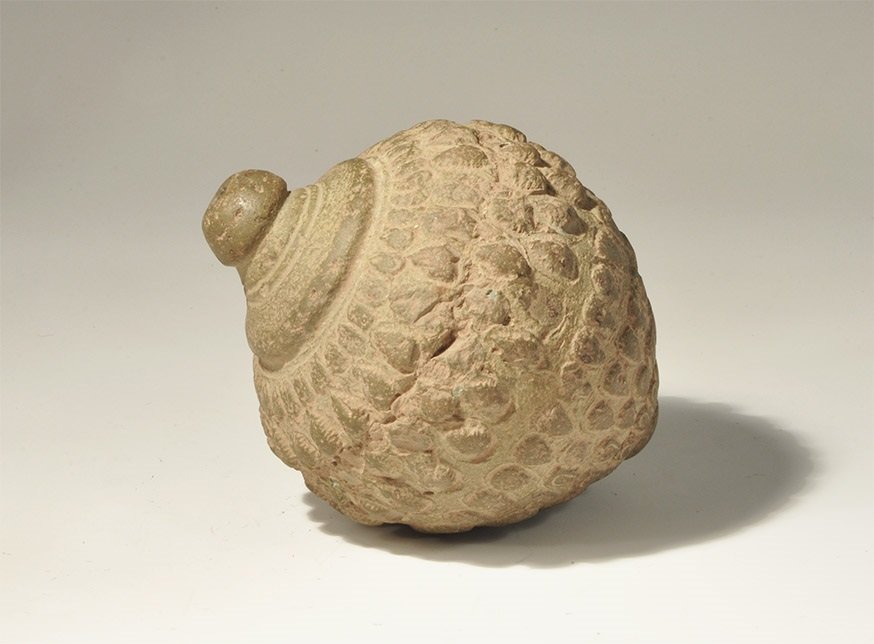 Byzantine Ceramic 'Greek Fire' Hand Grenade: 9th-11th century AD. A hollow ceramic vessel with domed top and conical base intended to be filled with explosive liquid and a wick, and used as a hand grenade; the body decorated with circumferential