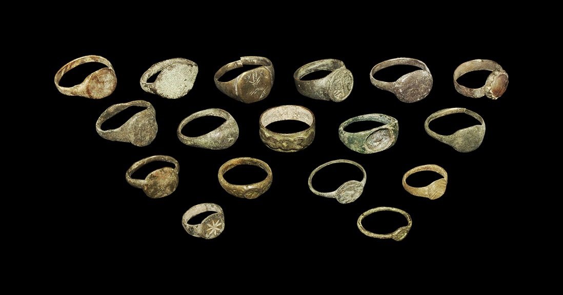 Byzantine to Medieval Bronze Finger Ring Group: 8th-16th century AD. A mixed group of finger rings comprising: four with rectangular bezel, geometric motifs; one with broad bezel and socket for an intaglio (absent); one with discoid bezel, Arabic t