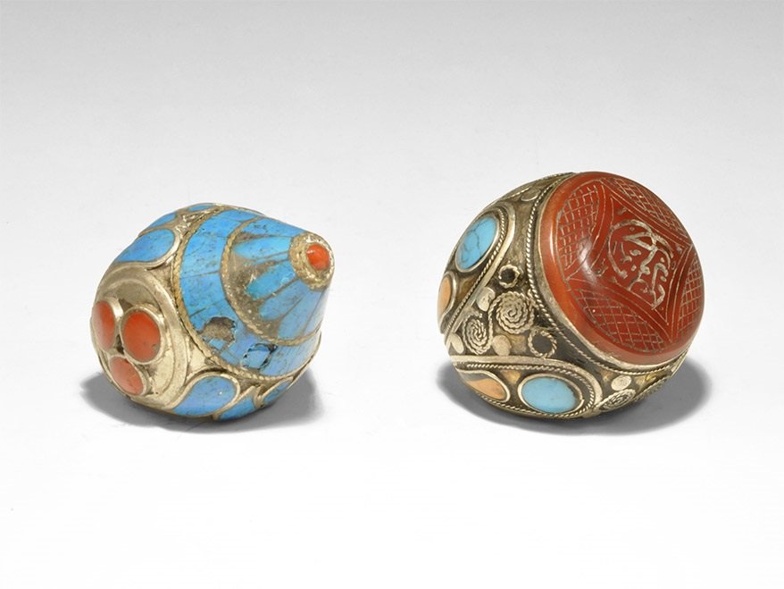 Chinese Silver Inlaid Finger Ring Pair: Nepalese or Tibetan, 20th century AD. A mixed group of finger rings comprising: one with filigree and pellets to the hoop, conical bezel inset with turquoise panels, groups of three carnelian panels t