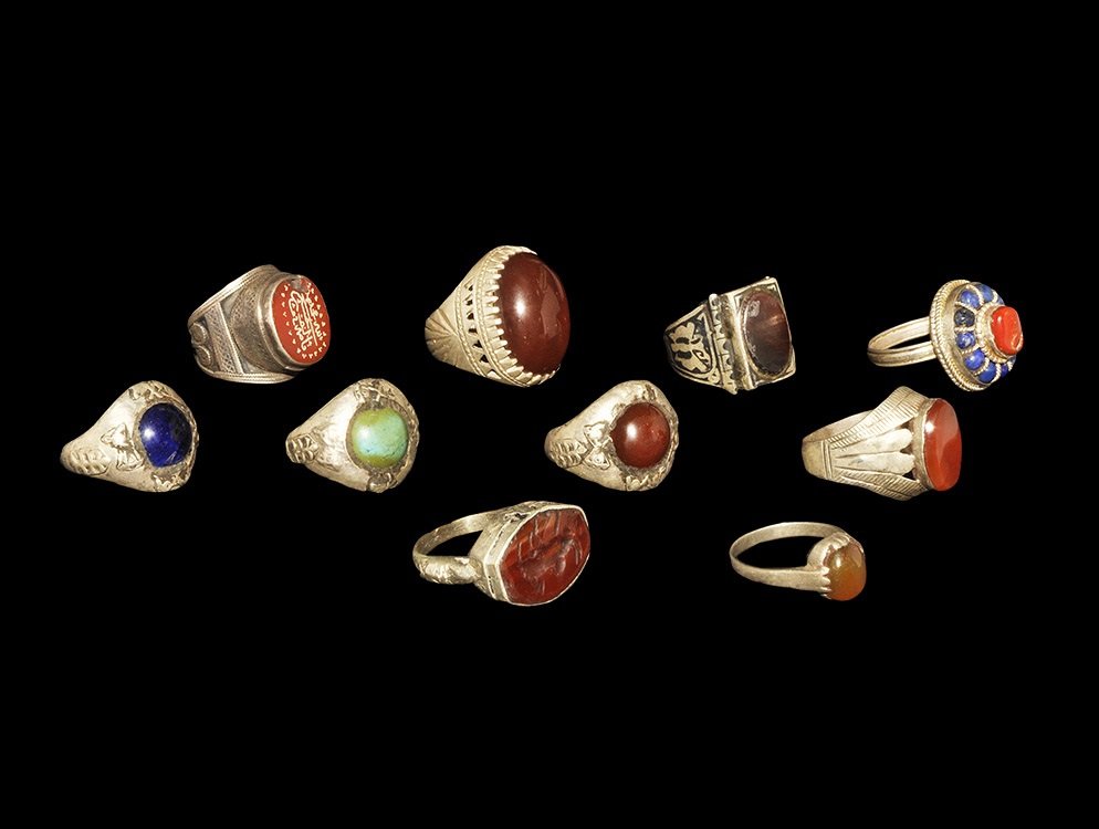 Vintage Silver Finger Ring Group: 20th century AD. A mixed group of finger rings comprising: six with cabochon inserts; one with intaglio cloison, ox motif; two with elliptical cloison inserts; one with calligraphic cloison; Central A