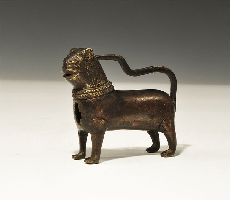 Islamic Style Bronze Lion Padlock: An undated archaistic barrel padlock with case formed as a hollow-cast lion with keyhole to the chest, the tail forming the strap. 233 grams, 95 mm (3 3/4"). Private collection, London, UK; acquired p