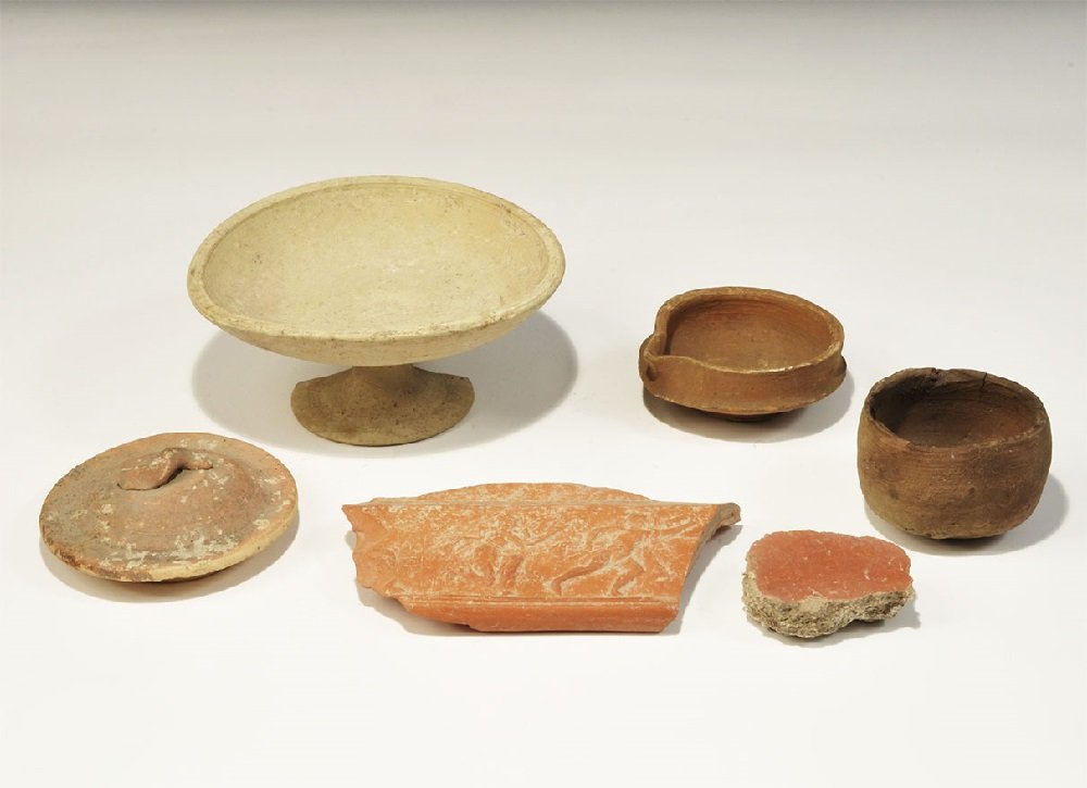 Greek and Other Ceramic Vessels Group: 4rd century BC and later. A mixed group of ceramic items comprising: an Apulian chalice with broad bowl; a plain pot with discoid base; a broad mixing vessel with pouring lip; a doomed lid with s-shap