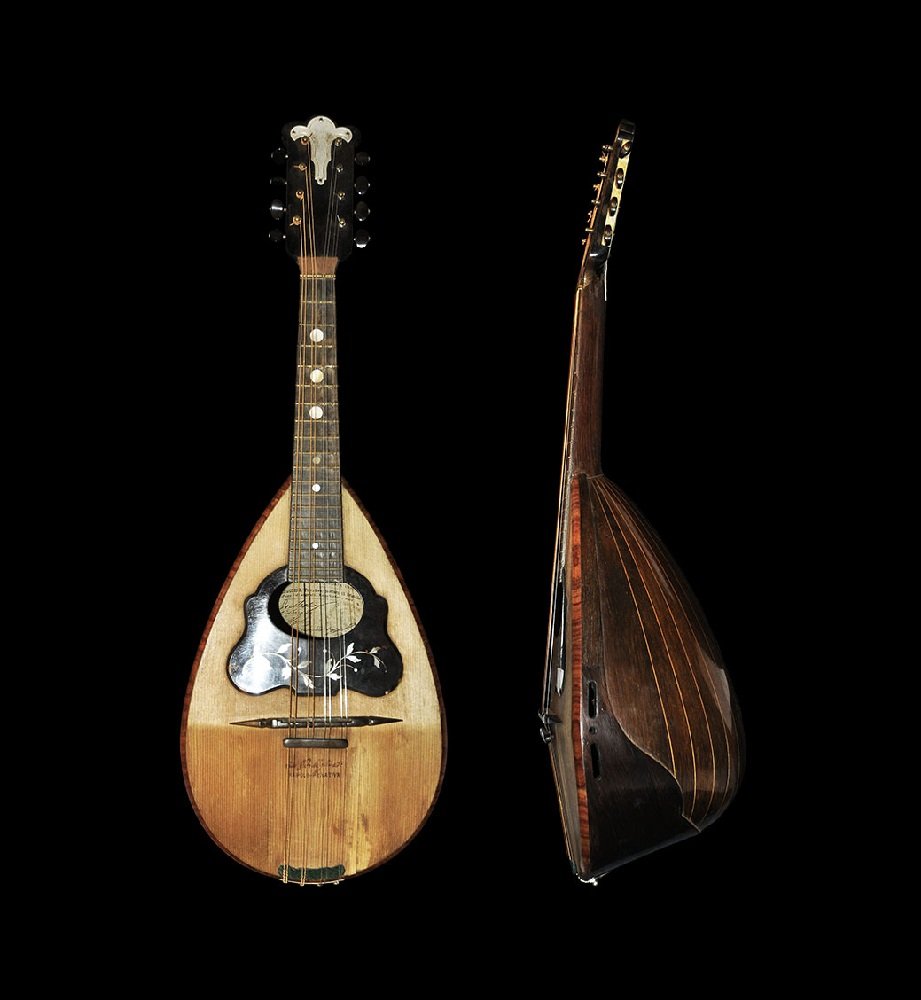Vintage Mandolin with Tortoise Shell and Mother of: Dated 1903. A handmade mandolin and leather case with eight strings, tortoise shell plaque to the sound hole with nacre inserts and discoid nacre panels to the frets; marked 'Cav. Giovanni de Meglio e